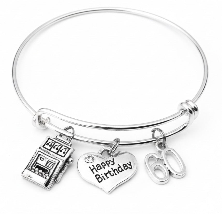 Silver bracelet with 'Happy Birthday' heart charm and other charms on a white background.  60th Birthday Slot Machine Charm Bracelet for Women – Adjustable Bangle Gift