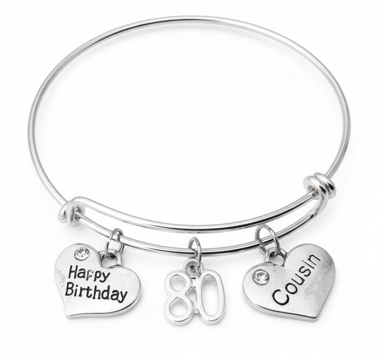 Silver bracelet with 'Happy Birthday', '80', and 'Cousin' charms on a white background