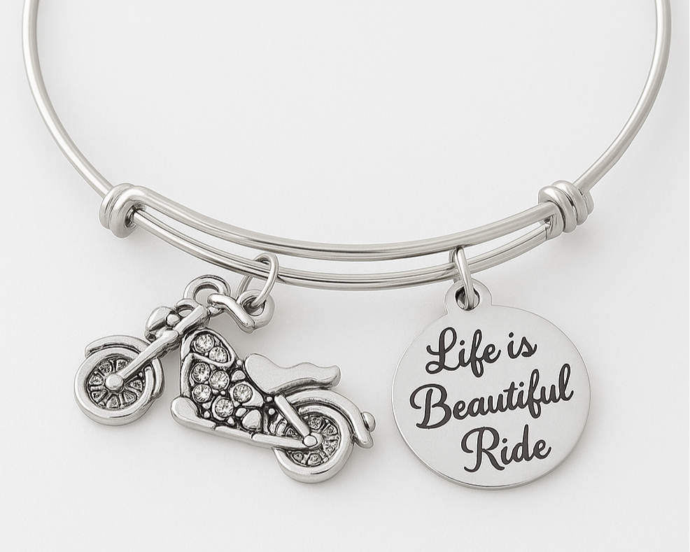 Silver bracelet with motorcycle charm and 'Life is Beautiful Ride' disc on a white background