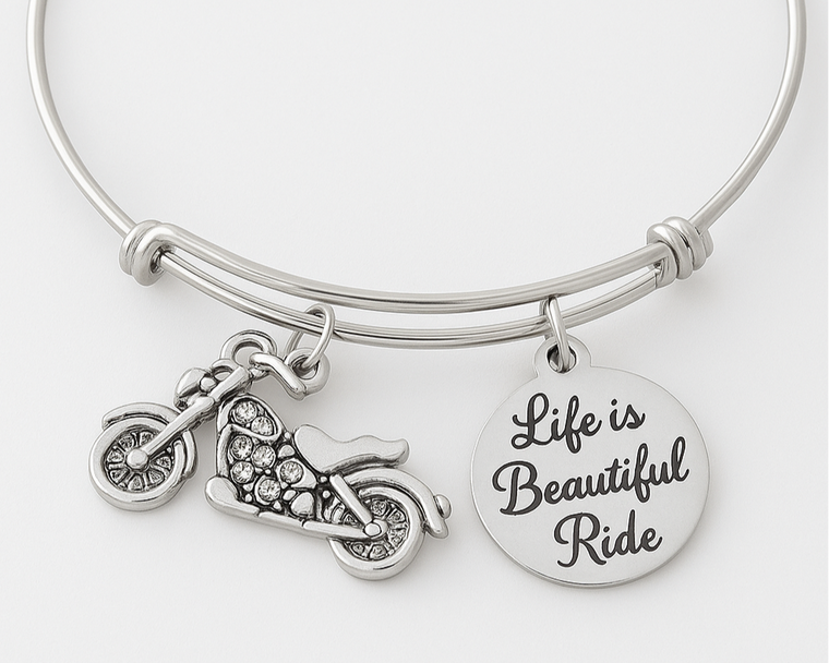 Silver bracelet with motorcycle charm and 'Life is Beautiful Ride' disc on a white background