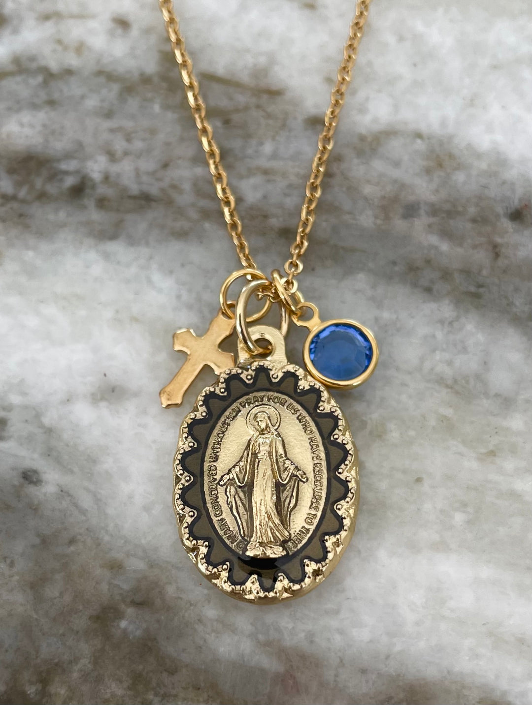 Catholic gold necklace featuring Miraculous Mary medal, Swarovski crystal birthstone, and stainless steel cross charm