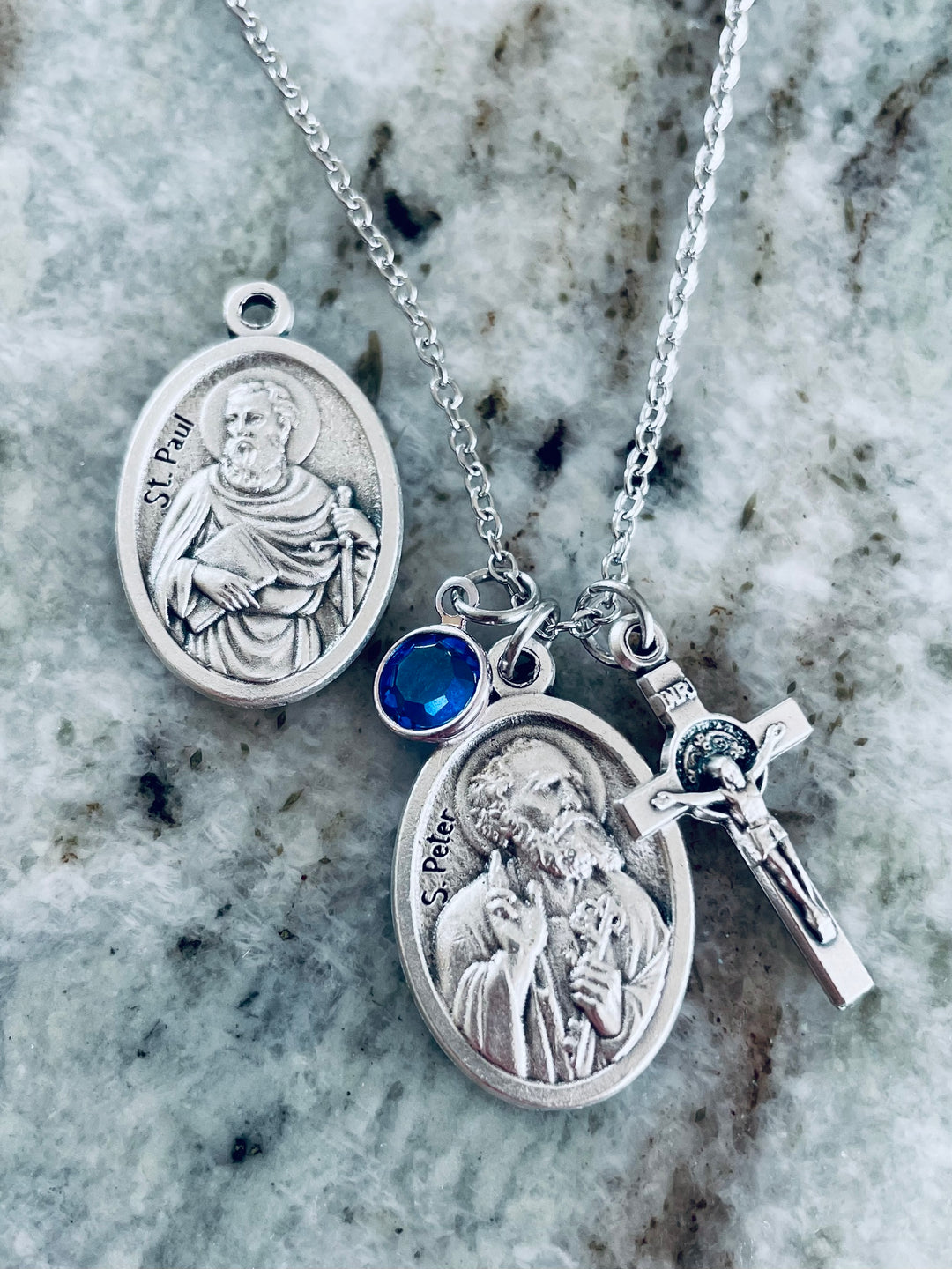 Two silver religious medals on a stainless steel chain St. Peter St. Paul