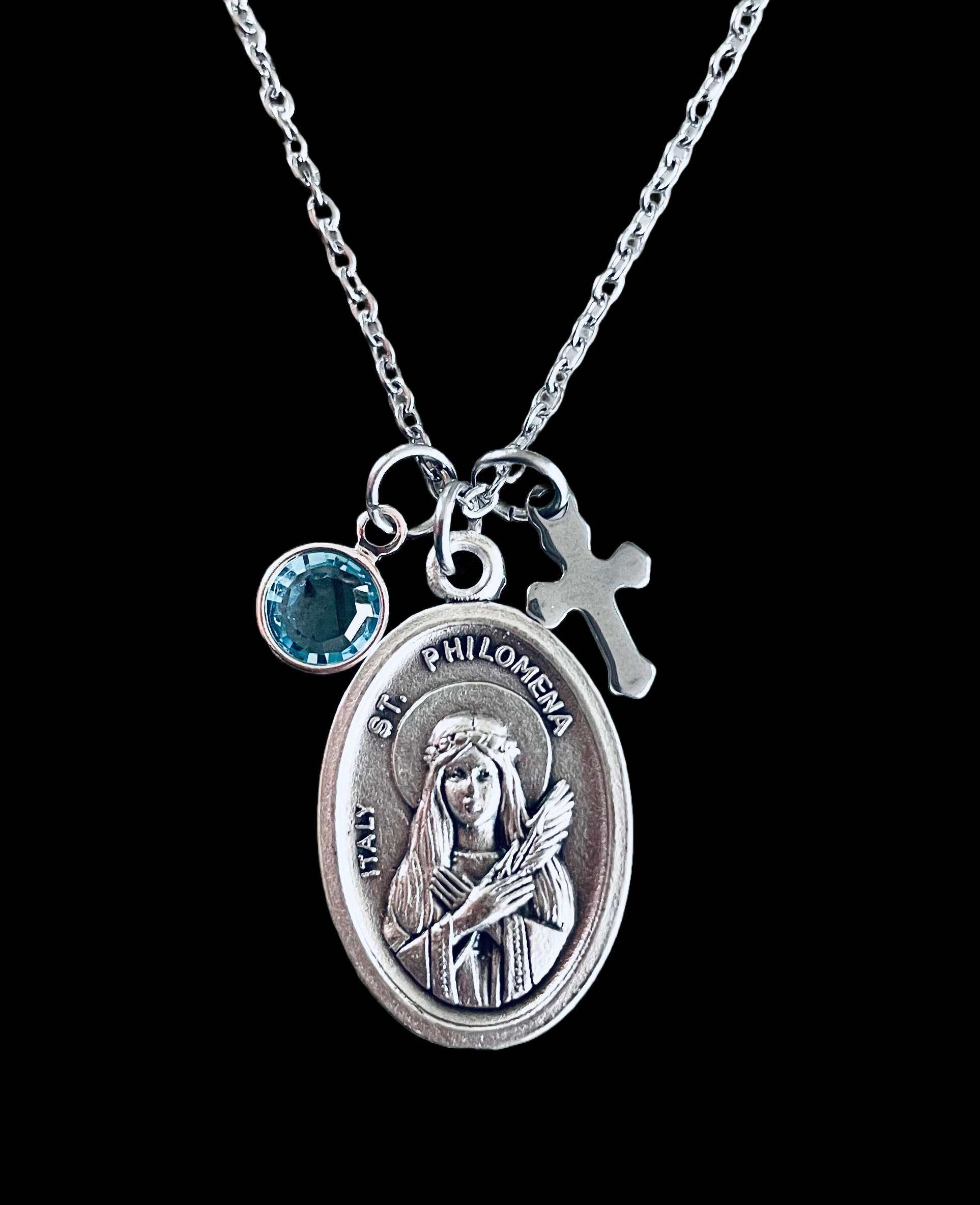 Saint Philomena necklace with silver medal, cross, and birthstone charm on adjustable chain