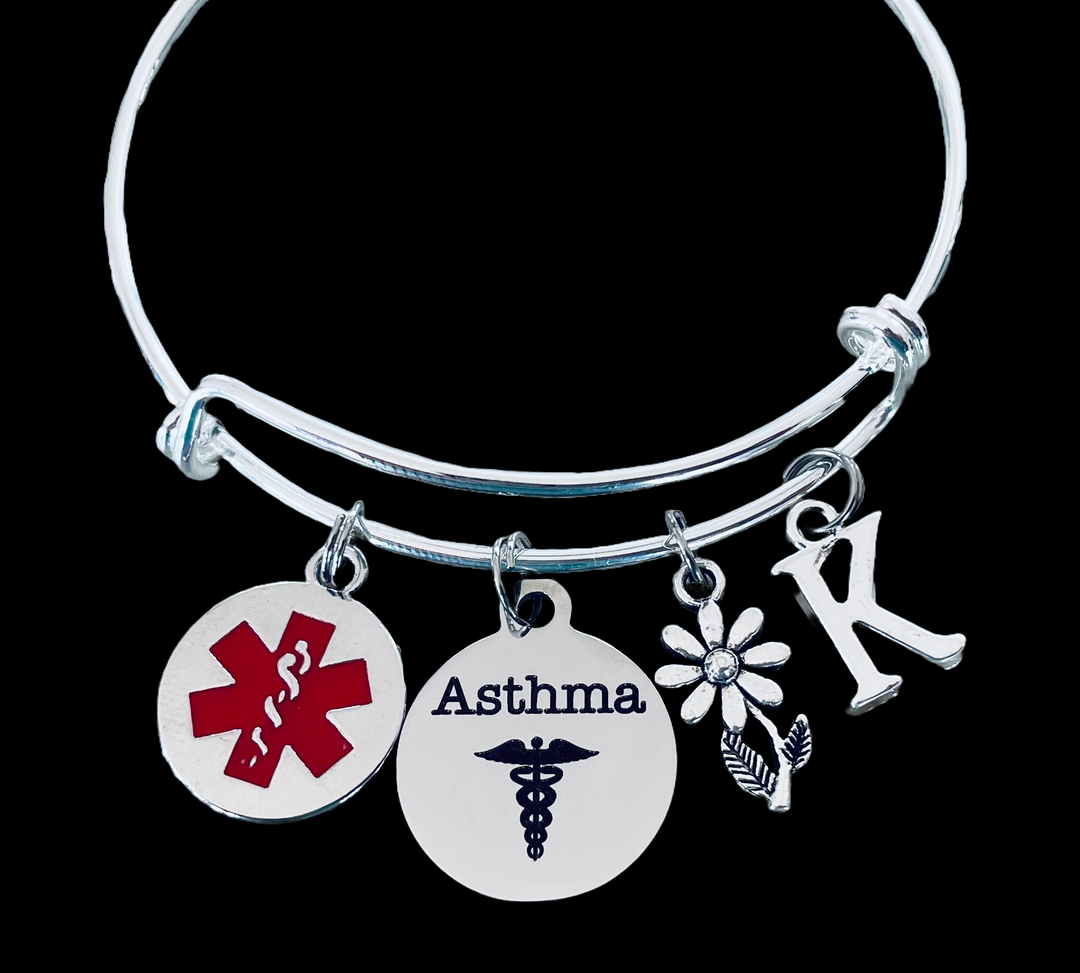 silver asthma medical alert bracelet with red Star of Life charm, “Asthma” disc, daisy flower, and personalized initial charm.