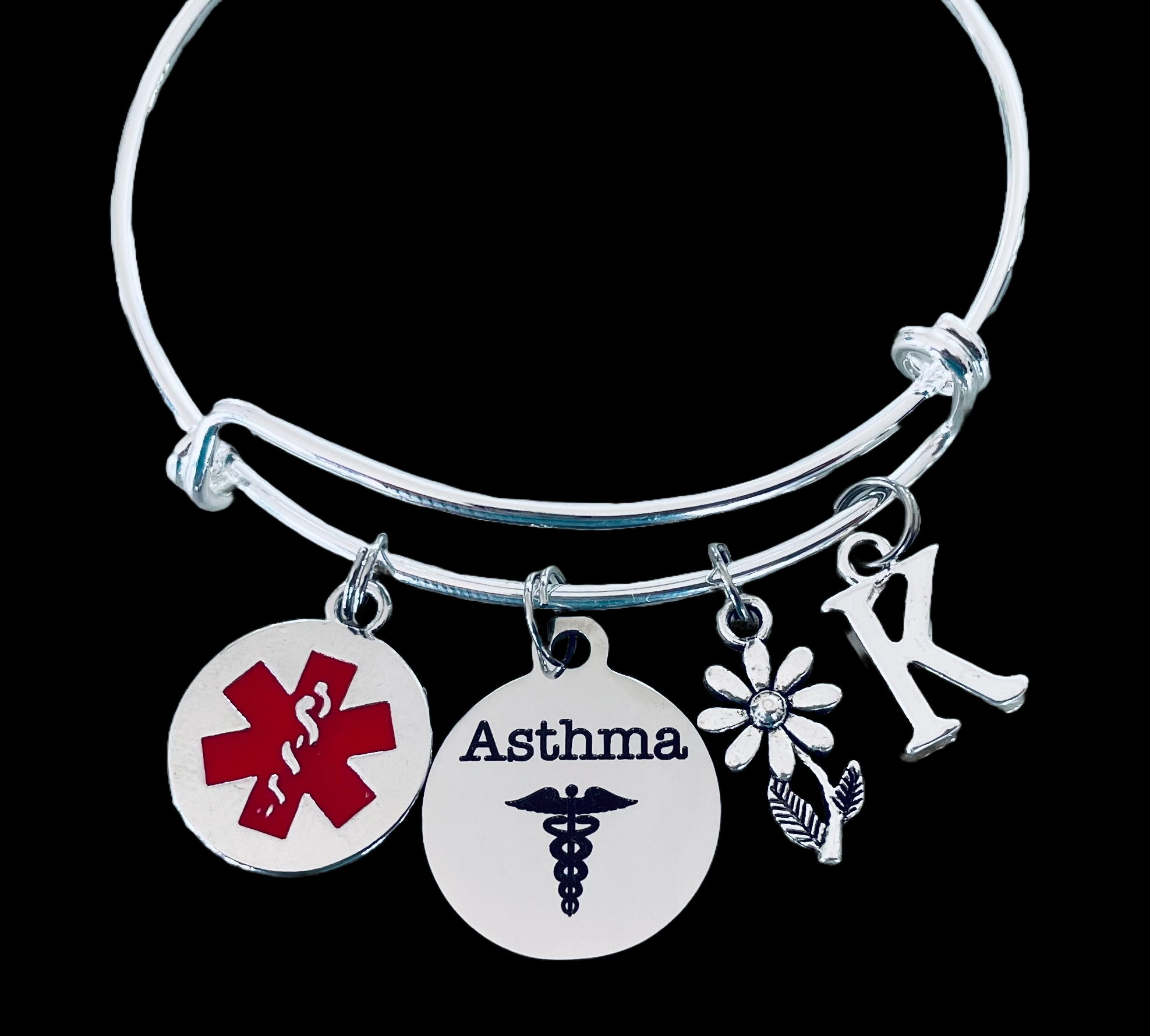 silver asthma medical alert bracelet with red Star of Life charm, “Asthma” disc, daisy flower, and personalized initial charm.