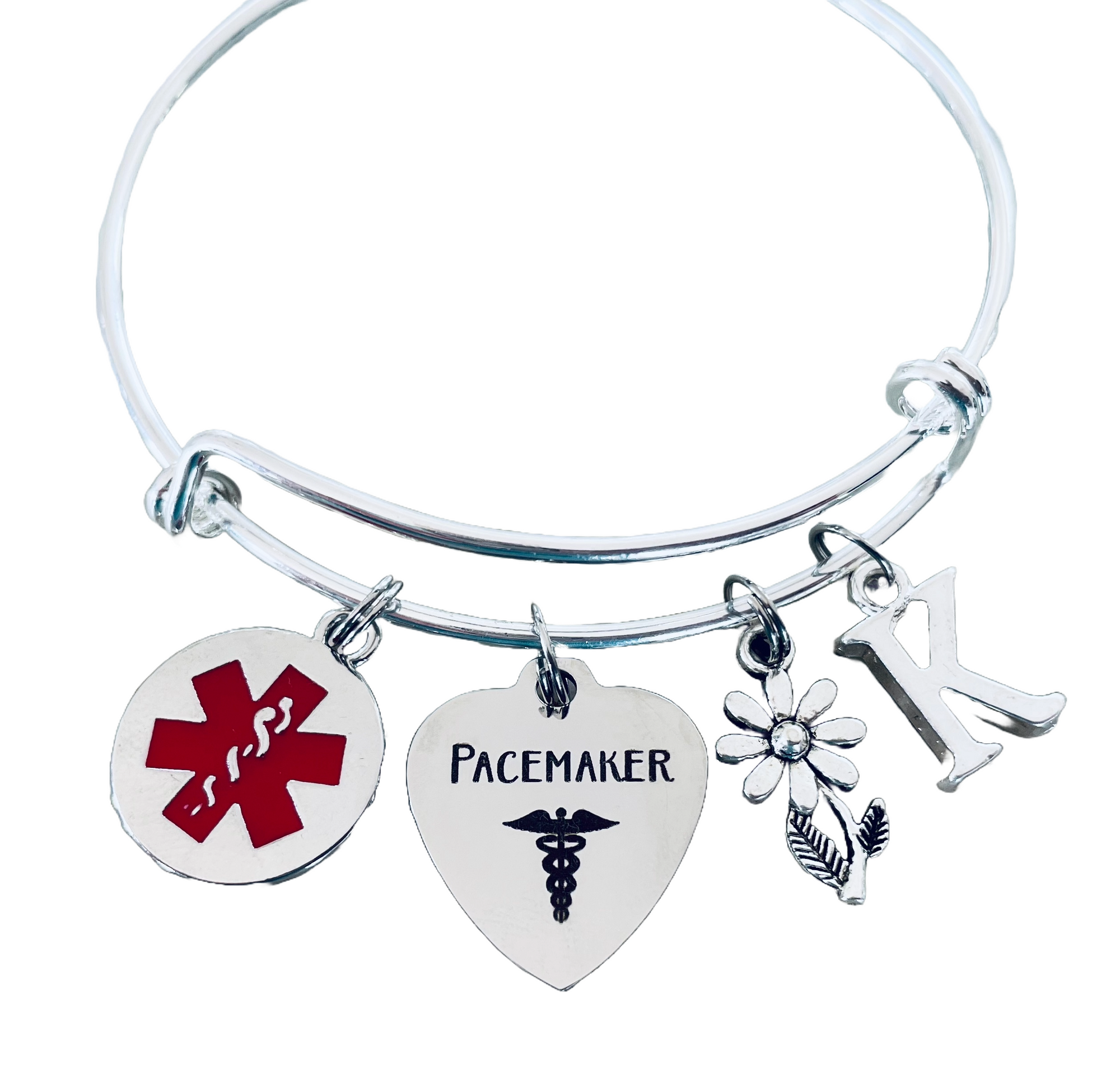 pacemaker medical alert bracelet with red symbol, and initial charm.