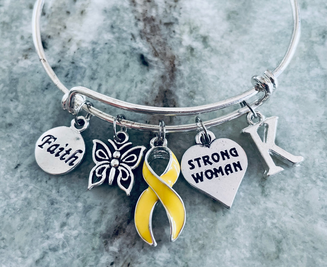 Strong Woman yellow ribbon charm bracelet with Faith, butterfly, and personalized initial on expandable silver bangle