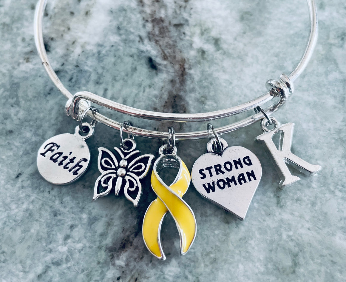 Strong Woman yellow ribbon charm bracelet with Faith, butterfly, and personalized initial on expandable silver bangle