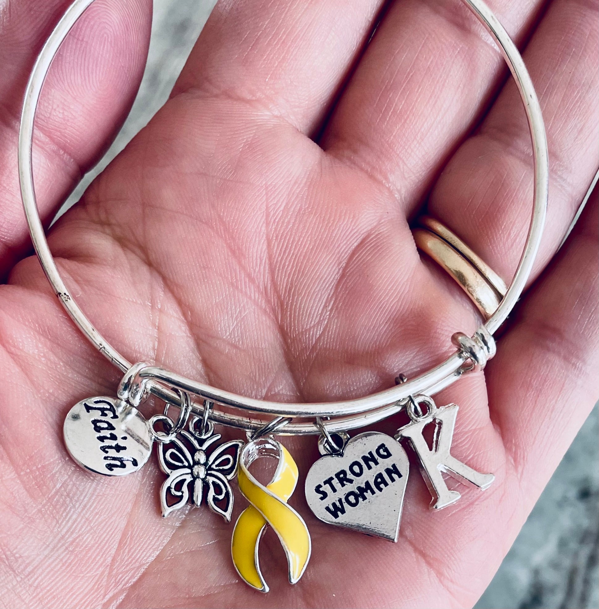 Custom yellow awareness bracelet with letter K initial and inspirational charms