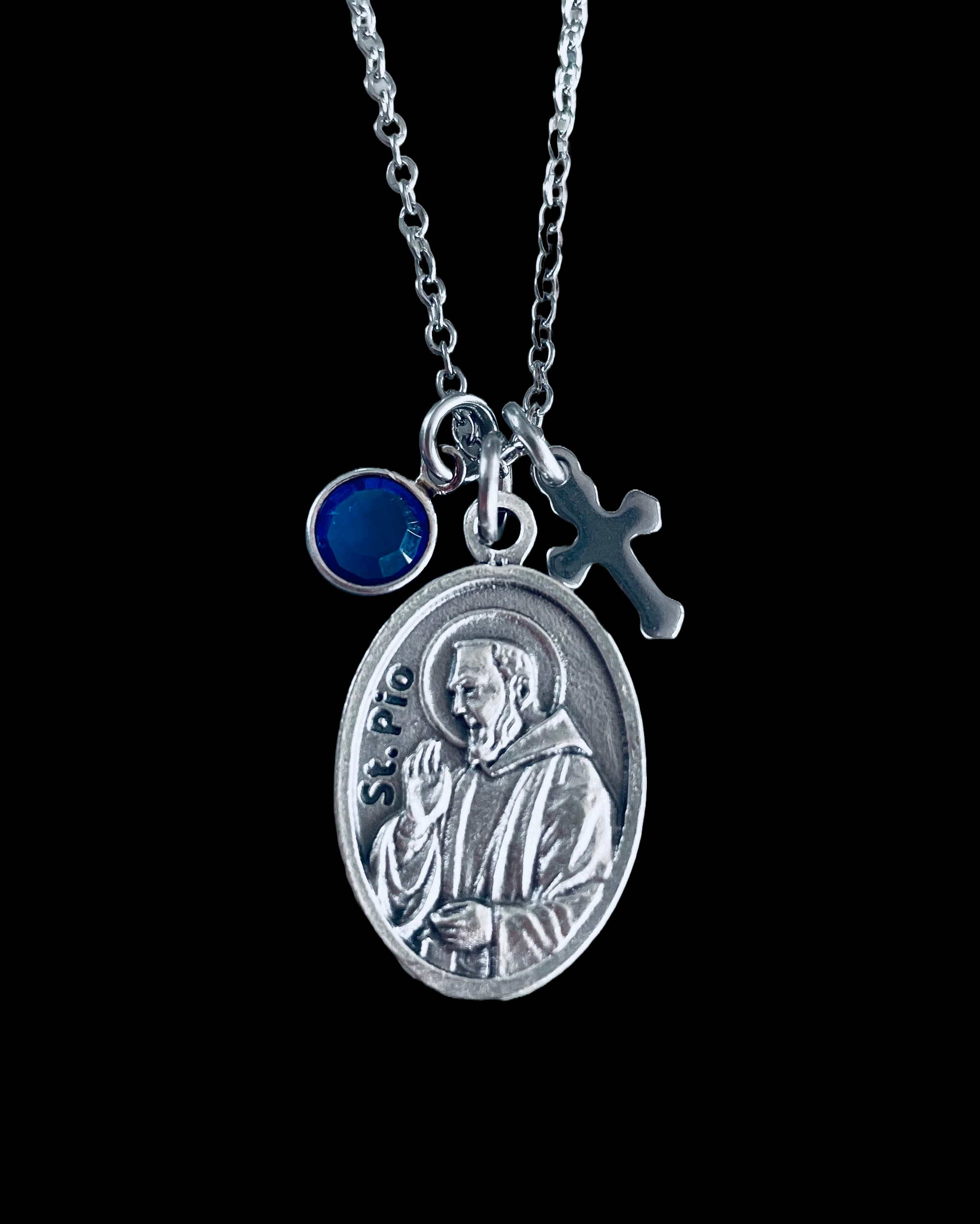 Religious charm necklace featuring Saint Pio, Swarovski crystal, and cross