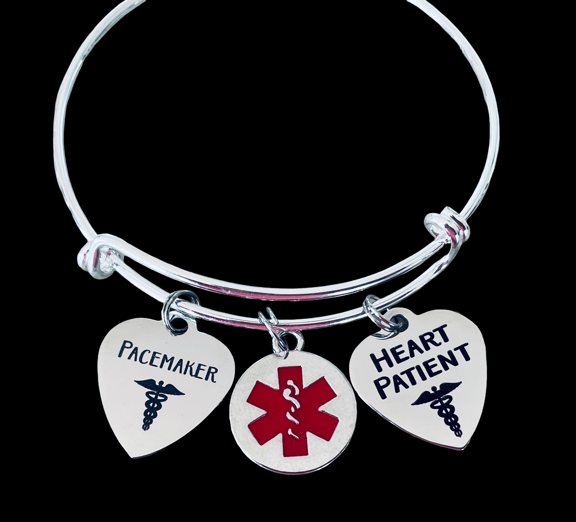 Silver expandable medical alert bracelet with stainless steel “Pacemaker,” “Heart Patient,” and red medical symbol charms