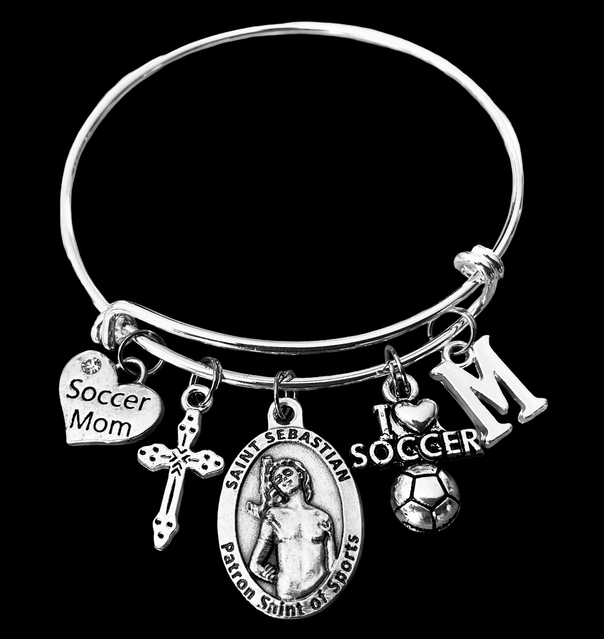 Silver expandable charm bracelet featuring a Saint Sebastian medal, Soccer Mom heart charm, cross, soccer ball charm, and personalized initial