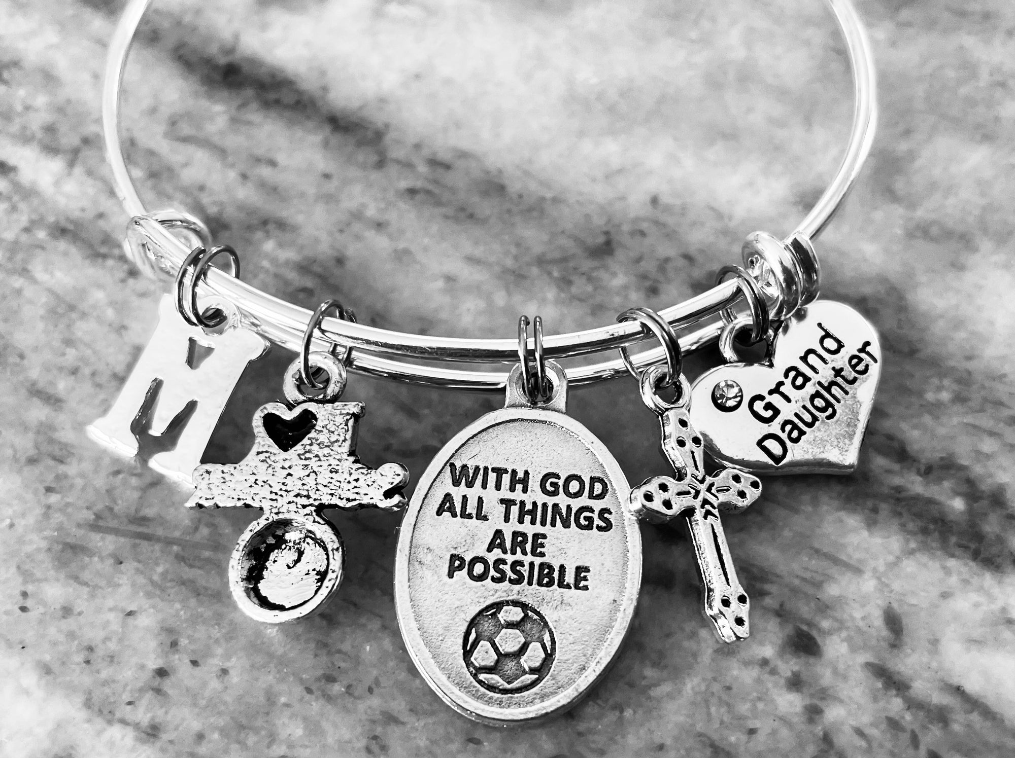 Granddaughter silver bangle bracelet with With God All Things Are Possible soccer medal, cross, initial, and heart Grand Daughter charm