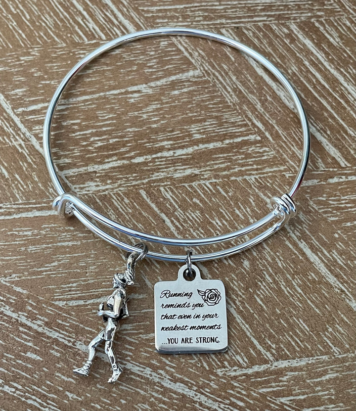 Silver bangle with a charm and motivational tag 