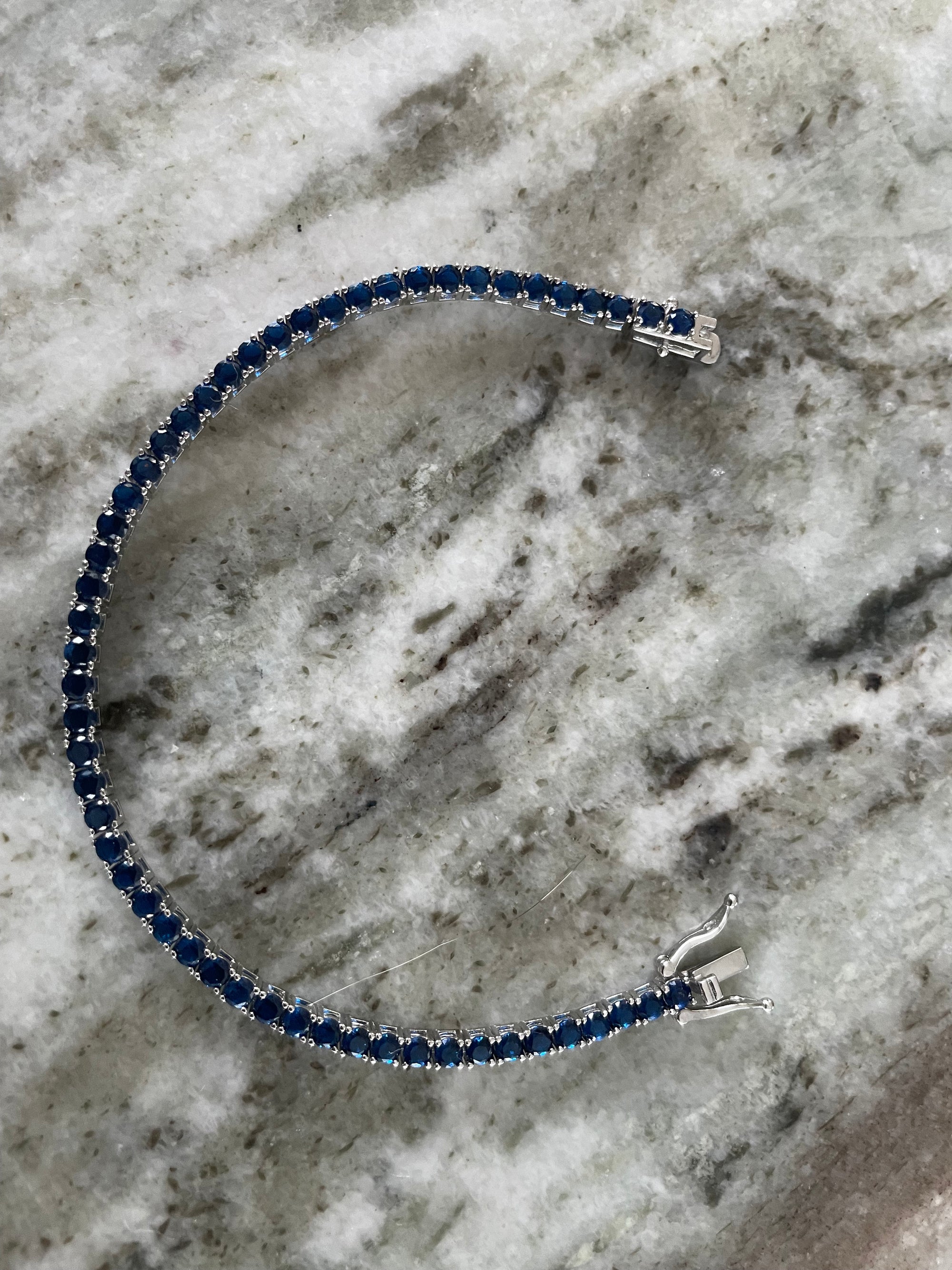Elegant 7.5 inch sterling silver bracelet with blue sapphires and triple locking clasp
