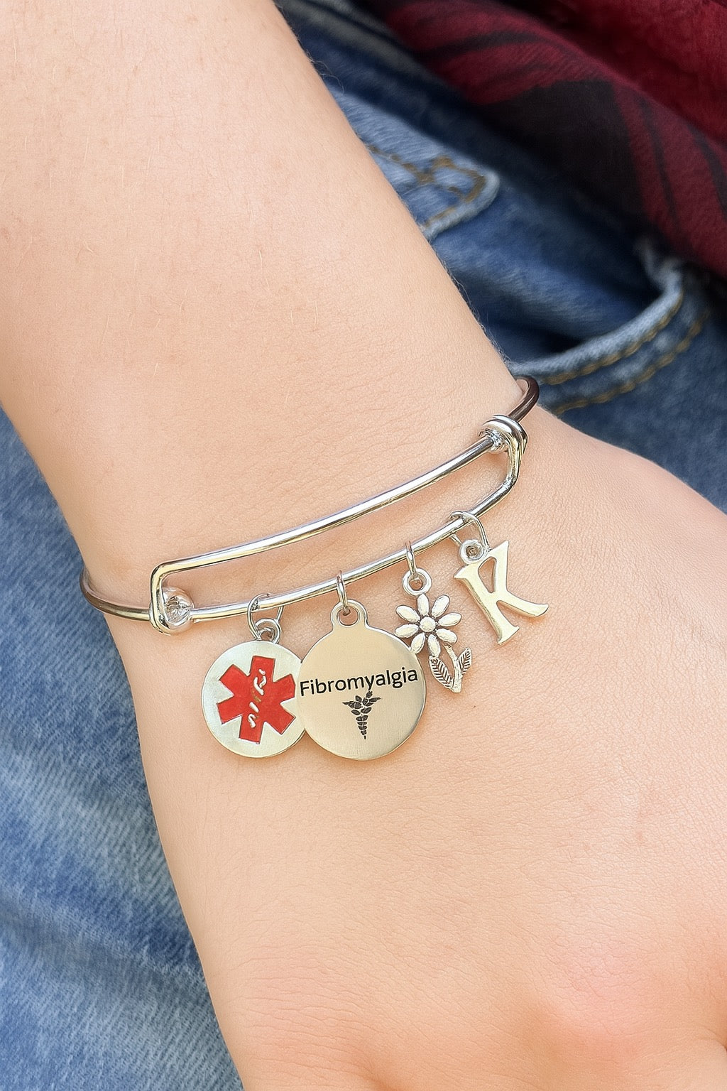 Personalized fibromyalgia awareness bracelet with medical alert charm and floral detail
