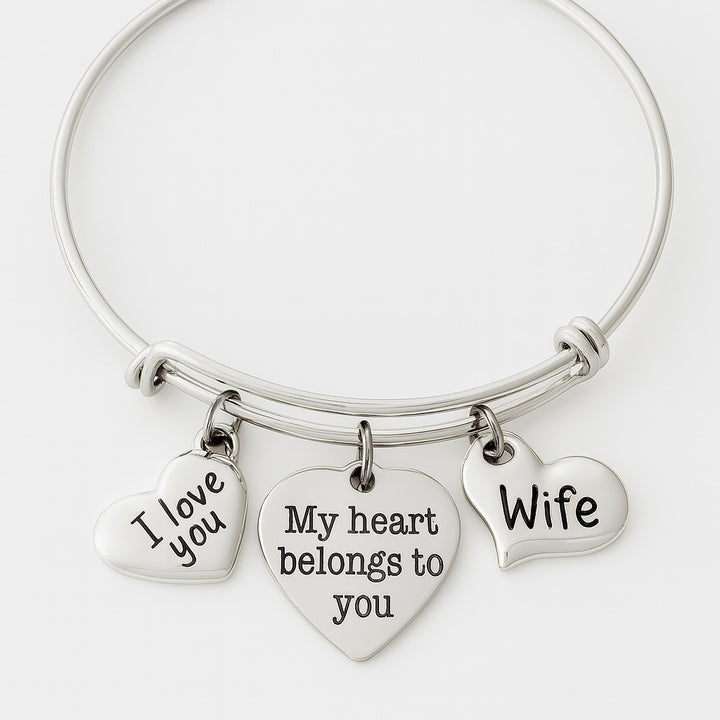 Silver expandable wife charm bracelet featuring three heart charms engraved with I Love You, My Heart Belongs to You, and Wife with crystal accent stone