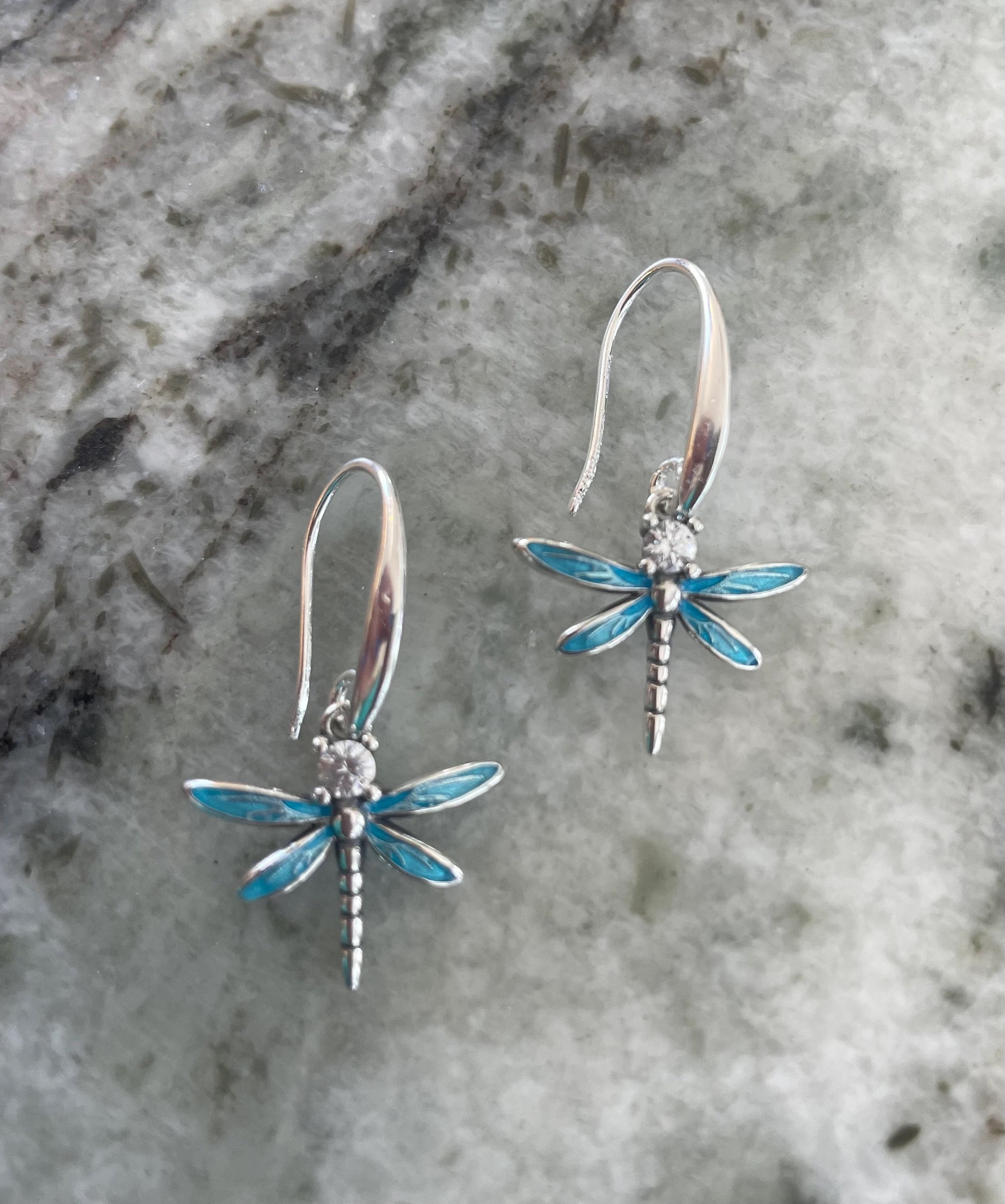 Nature-inspired sterling silver dragonfly earrings with shimmering blue wings and sparkling CZ crystals, lightweight dangle design