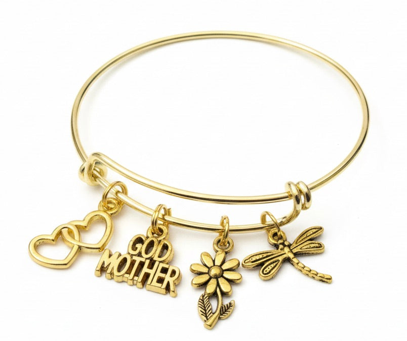 Gold expandable bangle bracelet with double open heart charm, God Mother word charm, daisy flower charm, and dragonfly charm – antique gold tone Godmother gift jewelry by Jules Obsession