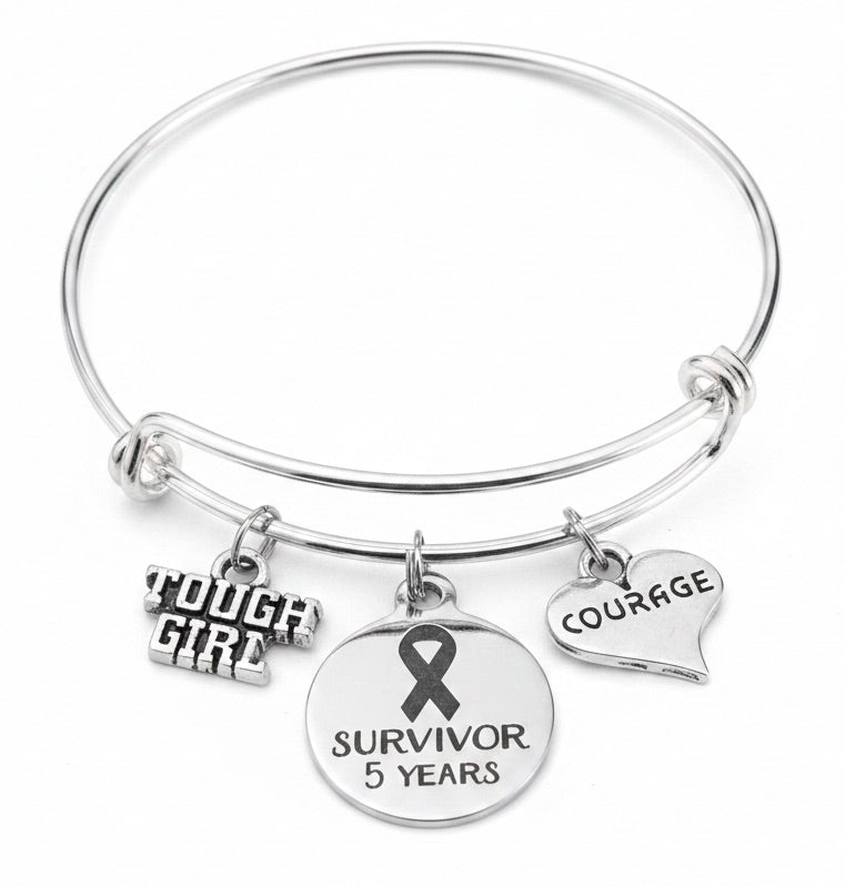 Jules Obsession silver adjustable bangle bracelet with cancer survivor 5 year ribbon charm, Tough Girl charm, and Courage heart charm — gift for cancer survivor