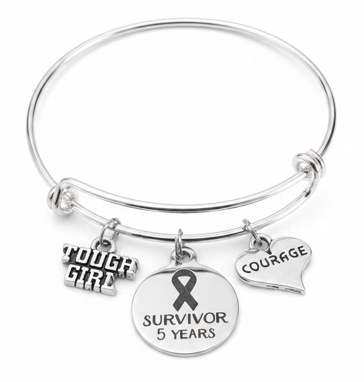 Jules Obsession silver adjustable bangle bracelet with cancer survivor 5 year ribbon charm, Tough Girl charm, and Courage heart charm — gift for cancer survivor