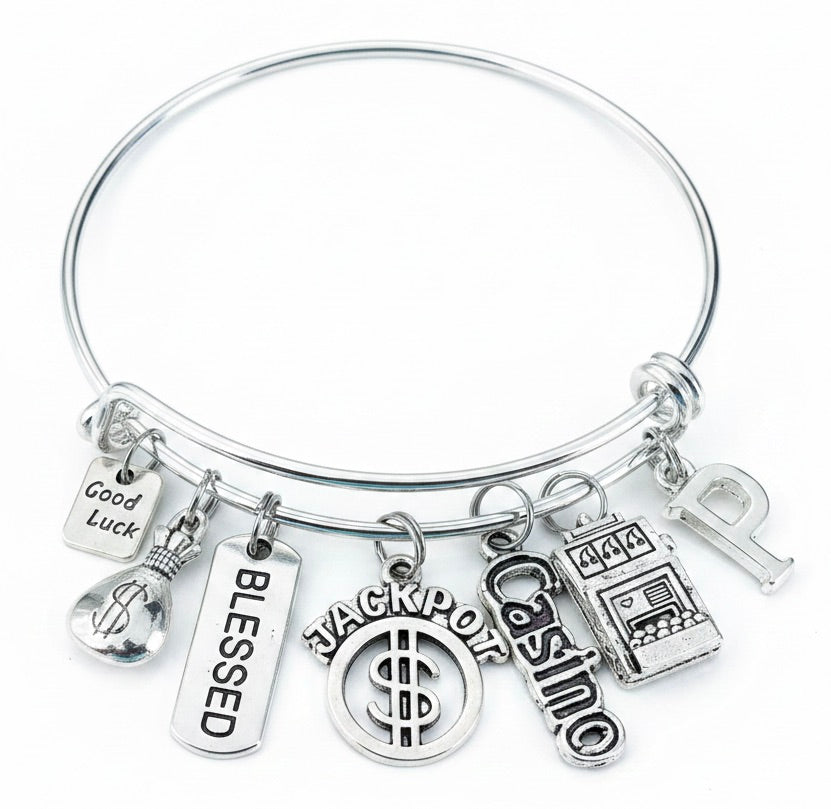 Personalized Casino Charm Bracelet with Good Luck, Money Bag, Blessed, Jackpot, Casino, and Slot Machine charms plus custom initial letter — silver expandable bangle by Jules Obsession, one size fits all