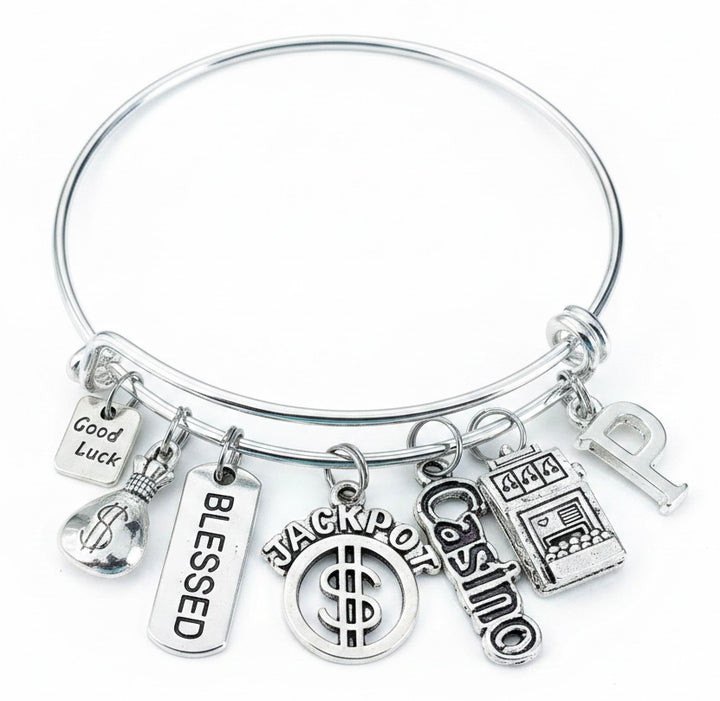 Personalized Casino Charm Bracelet with Good Luck, Money Bag, Blessed, Jackpot, Casino, and Slot Machine charms plus custom initial letter — silver expandable bangle by Jules Obsession, one size fits all