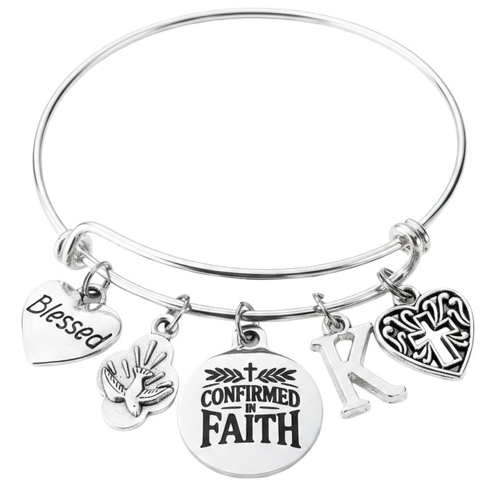 Silver-plated adjustable bangle bracelet featuring a stainless steel Confirmed in Faith medal, silver-plated Blessed heart charm, Holy Spirit Dove charm, Filigree Heart Cross charm, and personalized initial charm