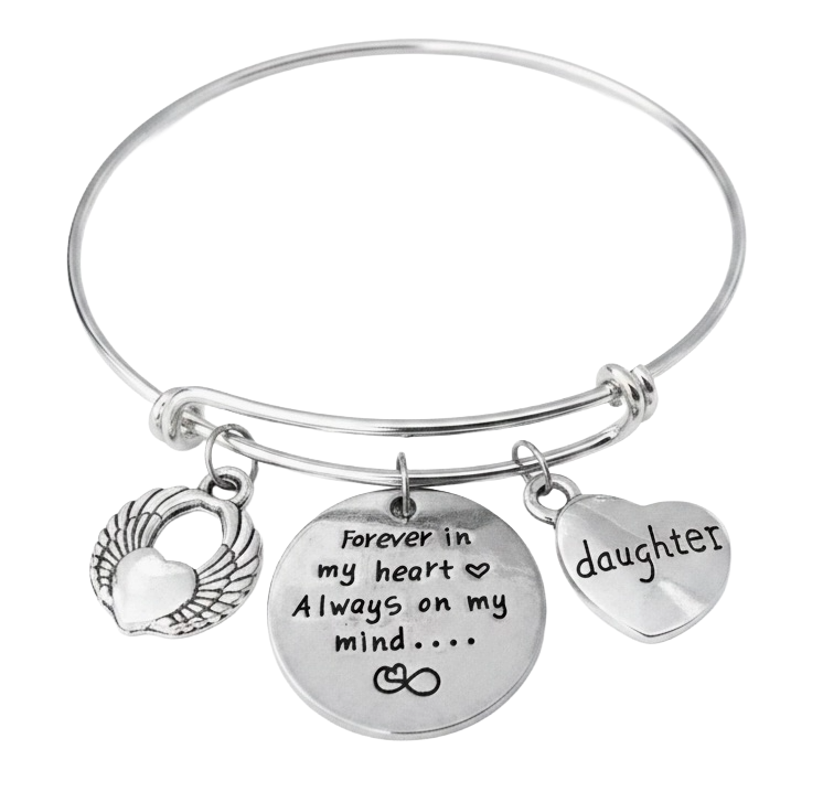 A silver-toned expandable bangle bracelet with three engraved charms: a winged heart, a round disc reading 'forever in my heart Always on my mind.
