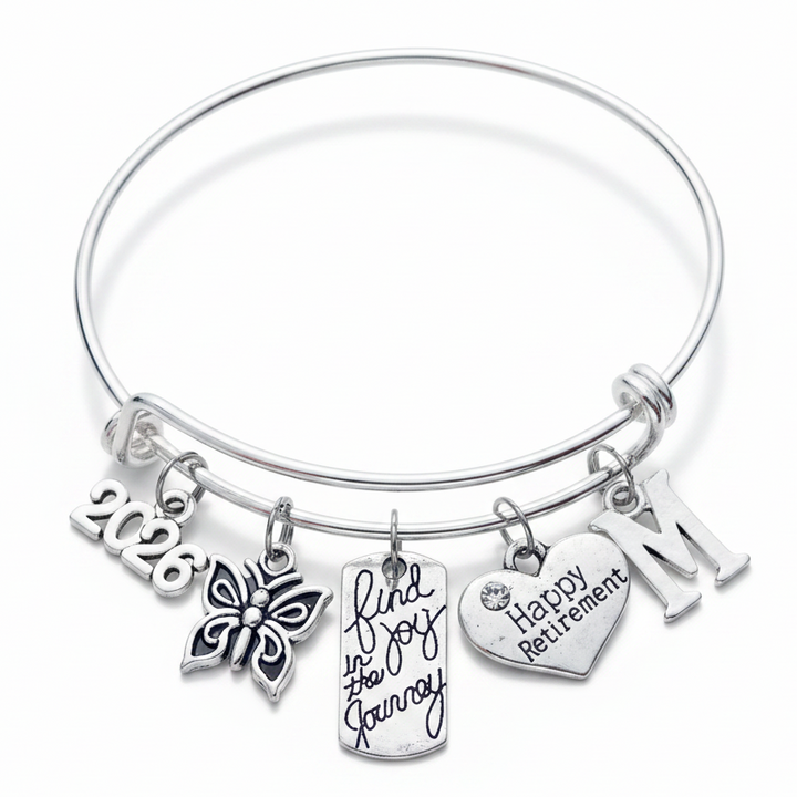 Silver expandable charm bangle with 2026 year charm, butterfly, Find Joy in the Journey tag, Happy Retirement heart, and initial charm – retirement gift for women by Jules Obsession"