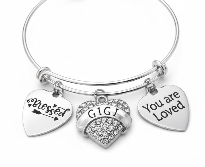 Silver bracelet with heart-shaped charms reading &