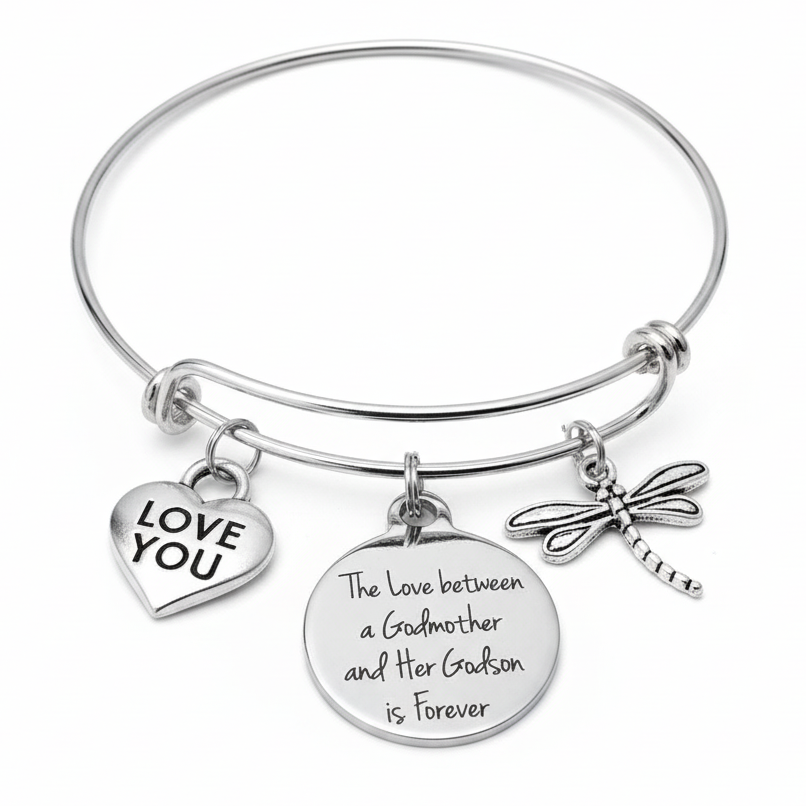 Silver bracelet with 'Love You' heart charm, round disc charm with engraved text, and dragonfly charm on a white background.