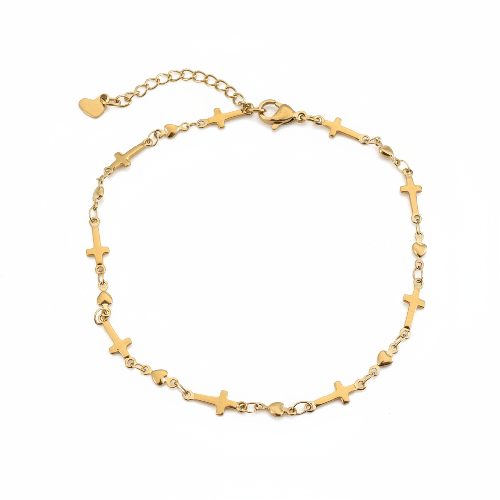 Gold cross and heart anklet worn on a model&