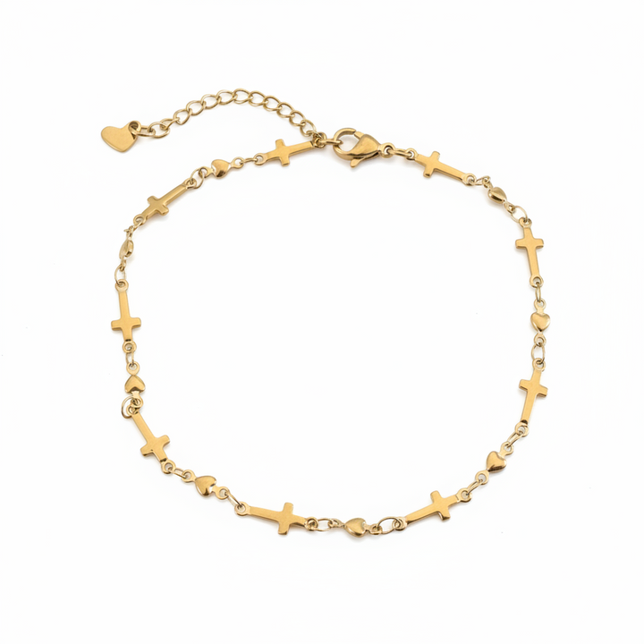 Gold cross and heart anklet worn on a model&