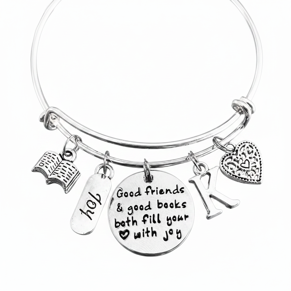 Personalized silver expandable bangle bracelet with open book charm, JOY tag, engraved Good Friends and Good Books quote disc, letter K initial charm, and filigree heart charm — gift for book lovers and best friends