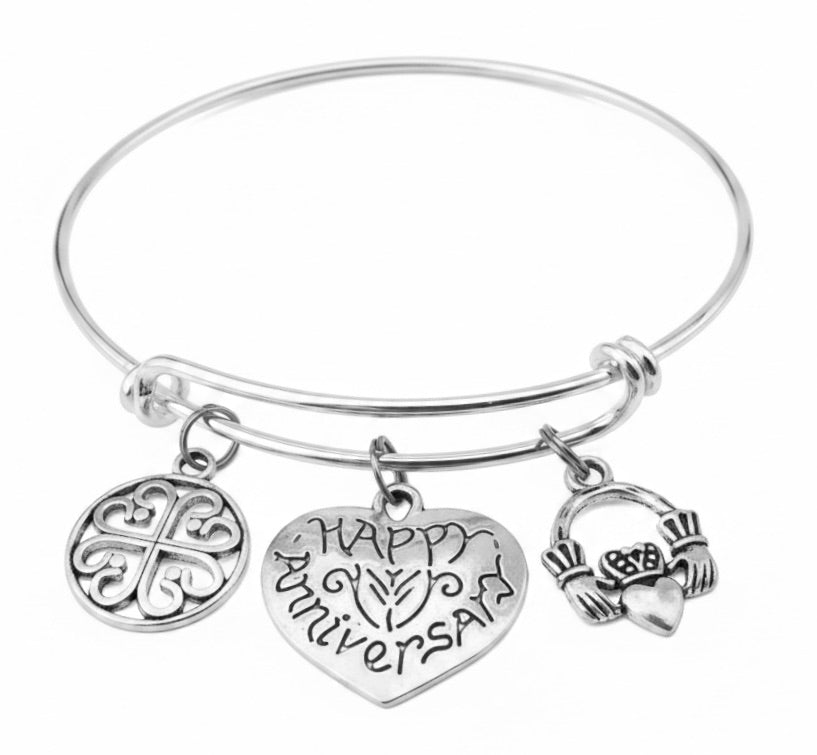 Happy Anniversary charm bracelet with Celtic filigree medallion, engraved Happy Anniversary heart charm, and Claddagh charm on silver adjustable bangle – anniversary gift jewelry for her"