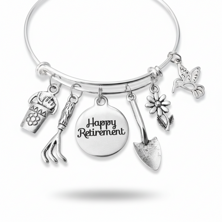 Happy Retirement garden charm bracelet with hummingbird, daisy, rake, trowel, flower pot and Happy Retirement disc charms on silver expandable bangle by Jules Obsession