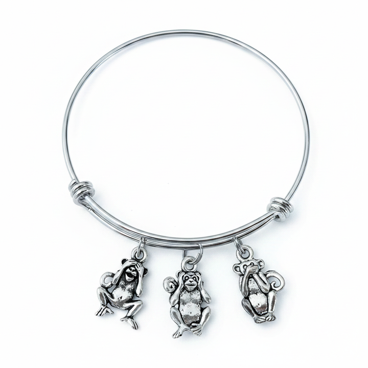 Silver expandable bangle bracelet with three antique silver see no evil hear no evil speak no evil monkey charms on white background – Jules Obsession handmade jewelry