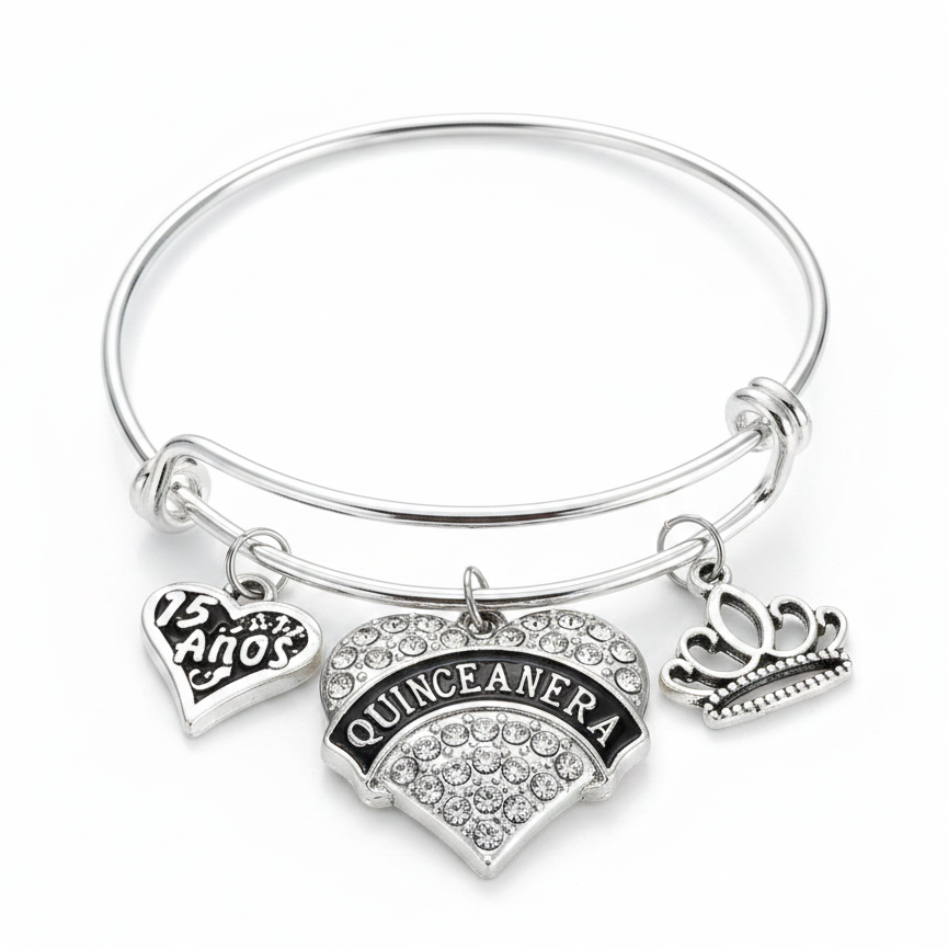 Silver Quinceañera charm bangle bracelet featuring a crystal-encrusted heart charm with black enamel, a 15 Años heart charm, and a silver tiara crown charm, on a white studio background
