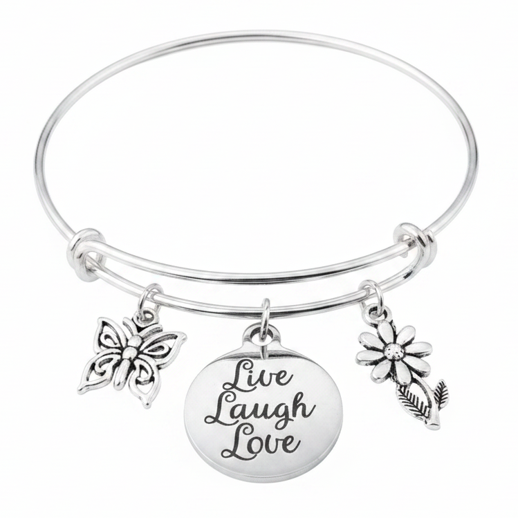 Silver expandable charm bangle bracelet with butterfly charm, Live Laugh Love engraved disc charm, and daisy flower charm each connected with a silver jump ring, handcrafted by Jules Obsession