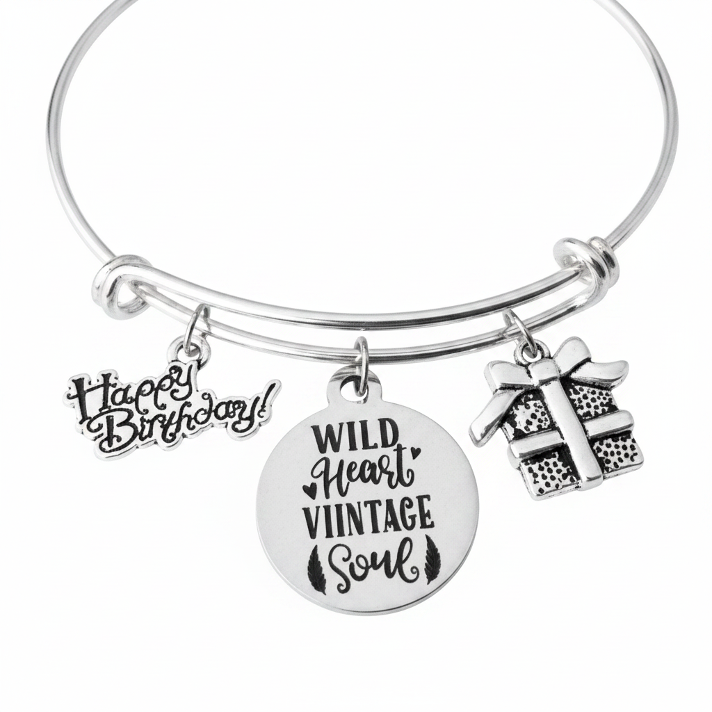 Silver expandable bangle bracelet with Happy Birthday script charm, Wild Heart Vintage Soul round engraved charm, and silver gift box charm — handmade by Jules Obsession