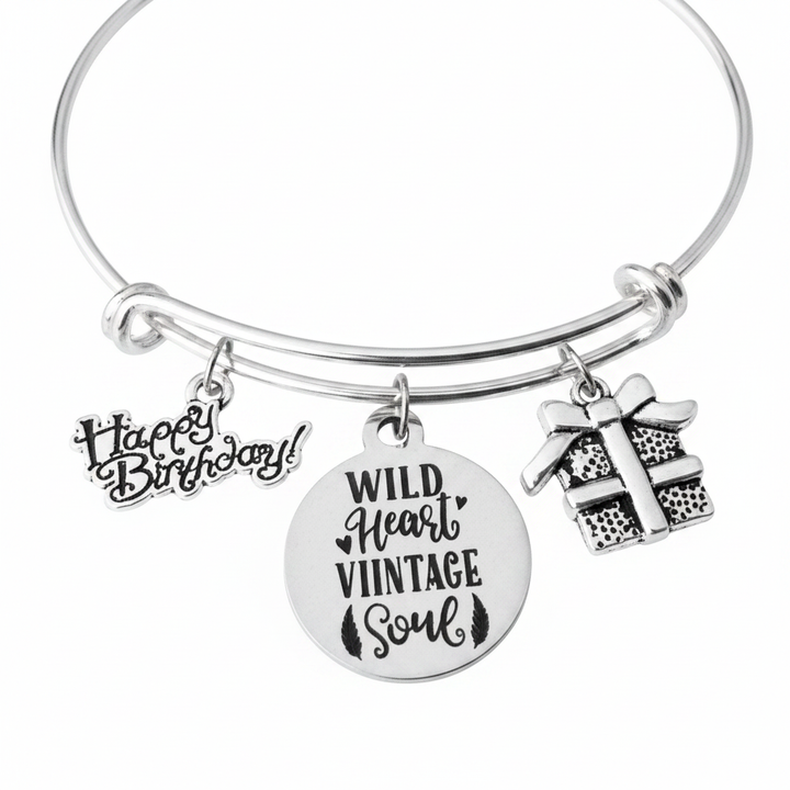 Silver expandable bangle bracelet with Happy Birthday script charm, Wild Heart Vintage Soul round engraved charm, and silver gift box charm — handmade by Jules Obsession