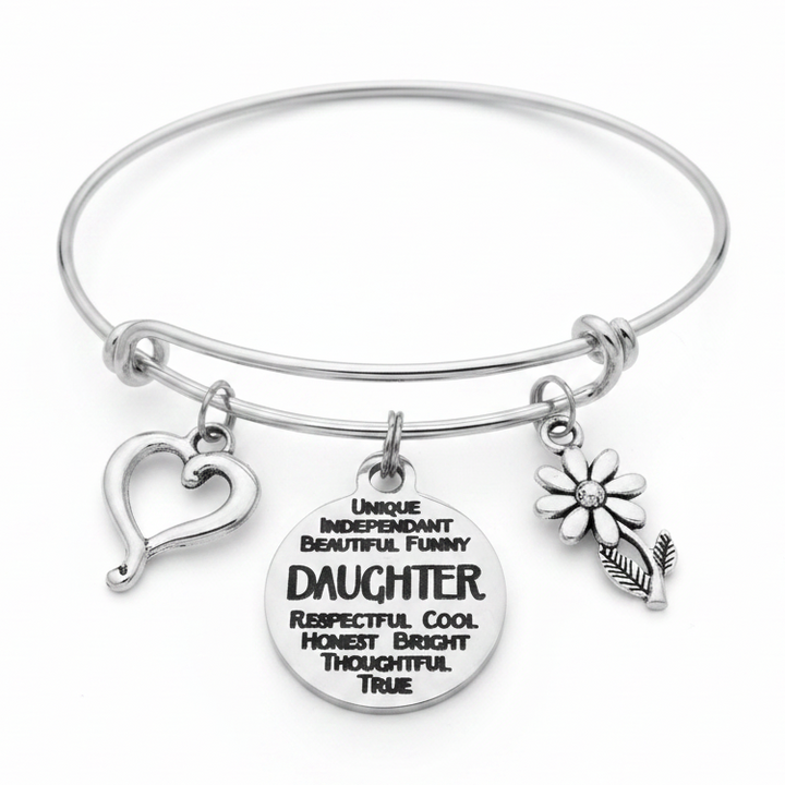 Silver expandable bangle bracelet with engraved Daughter quote disc charm, open heart charm, and daisy flower charm on white background – daughter gift by Jules Obsession