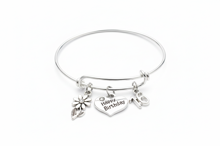 Sweet 16 birthday charm bracelet with Happy Birthday heart flower and number 16 charms on bright silver expandable bangle