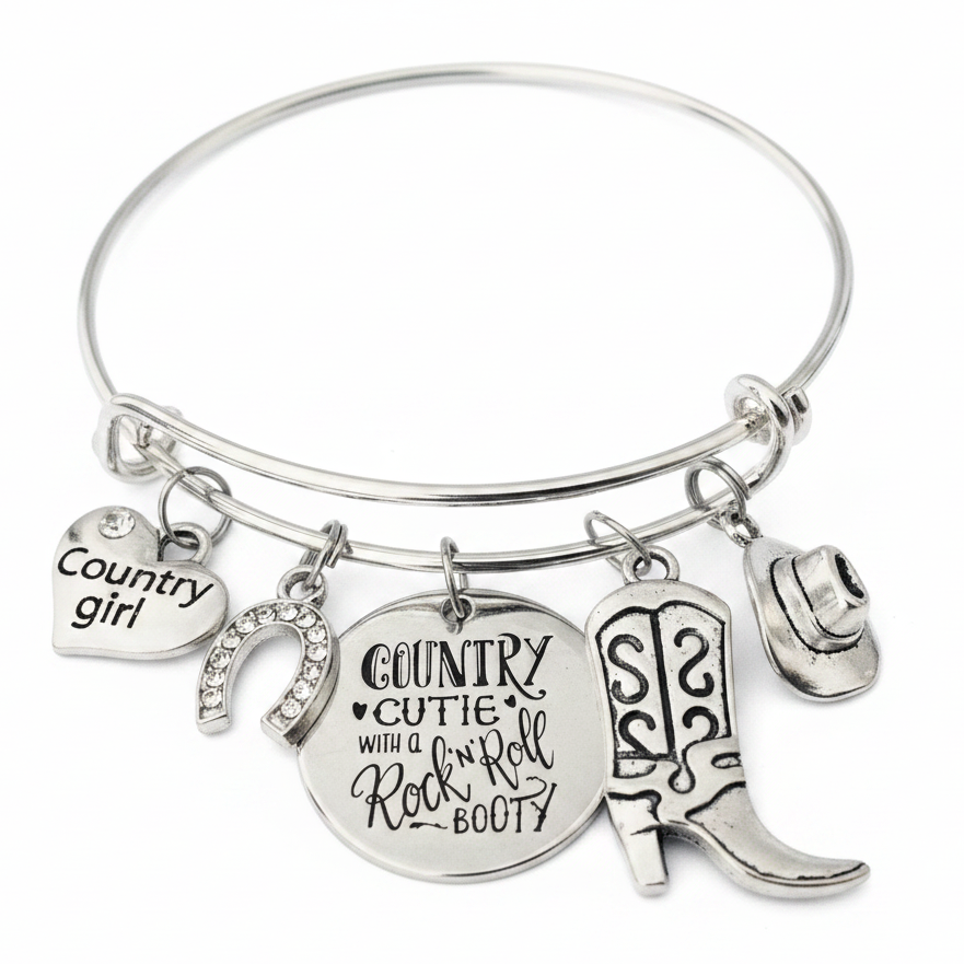 Silver expandable charm bangle bracelet with country girl heart, crystal horseshoe, cowboy boots, cowboy hat, and engraved Country Cutie disc charms on white background