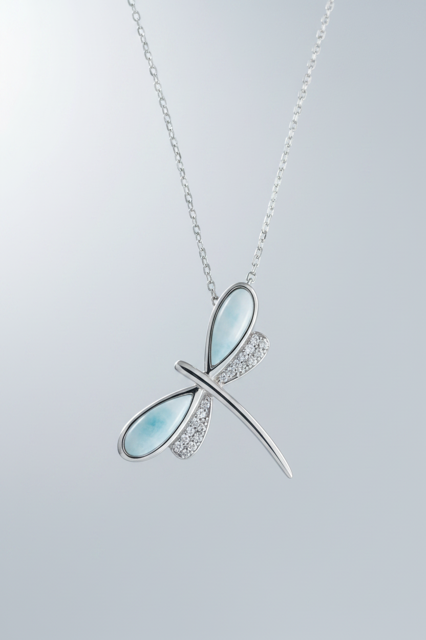 Sterling silver dragonfly pendant necklace featuring mother-of-pearl blue stone wings and pavé crystal wings on a delicate silver chain