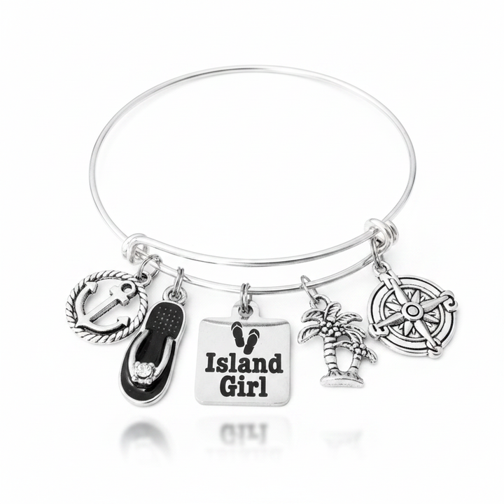 Island Girl silver expandable bangle bracelet with anchor, flip flop, palm tree, and compass charms on pure white background — beach jewelry gift for her