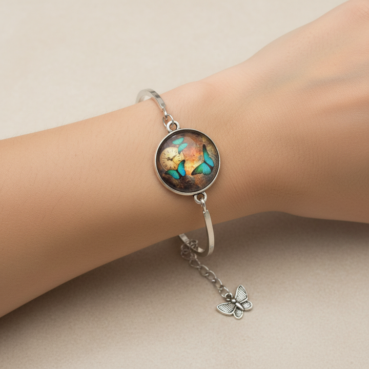 Woman wearing teal butterfly and clock glass dome silver adjustable cuff bracelet with butterfly charm – nature jewelry by Jules Obsession