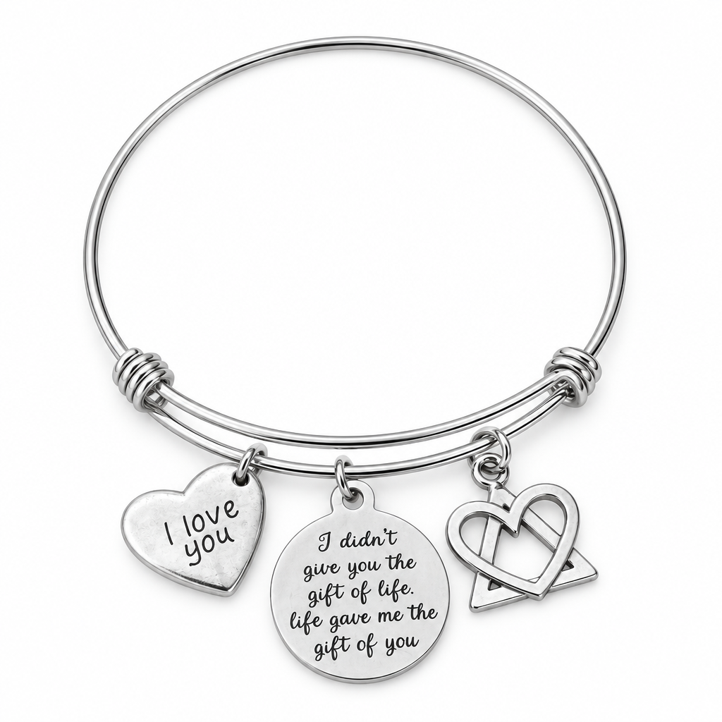 Silver bangle bracelet with I love you heart, gift of life engraved disc, and heart-and-triangle charms on white.