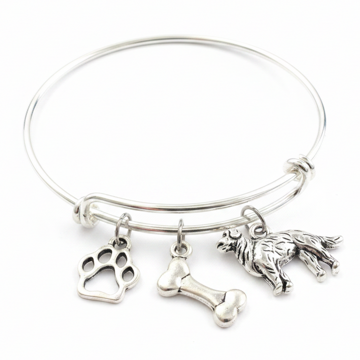 Silver expandable bangle bracelet with Labrador Retriever dog charm, paw print charm, and dog bone charm on white background – Jules Obsession dog lover jewelry gift